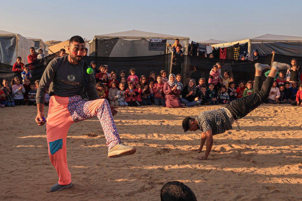 Men dressed as clowns perform for children participating in an activity aimed to support their mental health, amid continuing battles between Israel and the militant group Hamas, in Rafah in the southern Gaza Strip.
