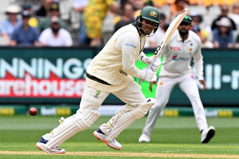 Australia's batsman Usman Khawaja has the names of his children written on his boots on the first day of the second cricket Test match between Australia and Pakistan at the Melbourne Cricket Ground (MCG) in Melbourne.