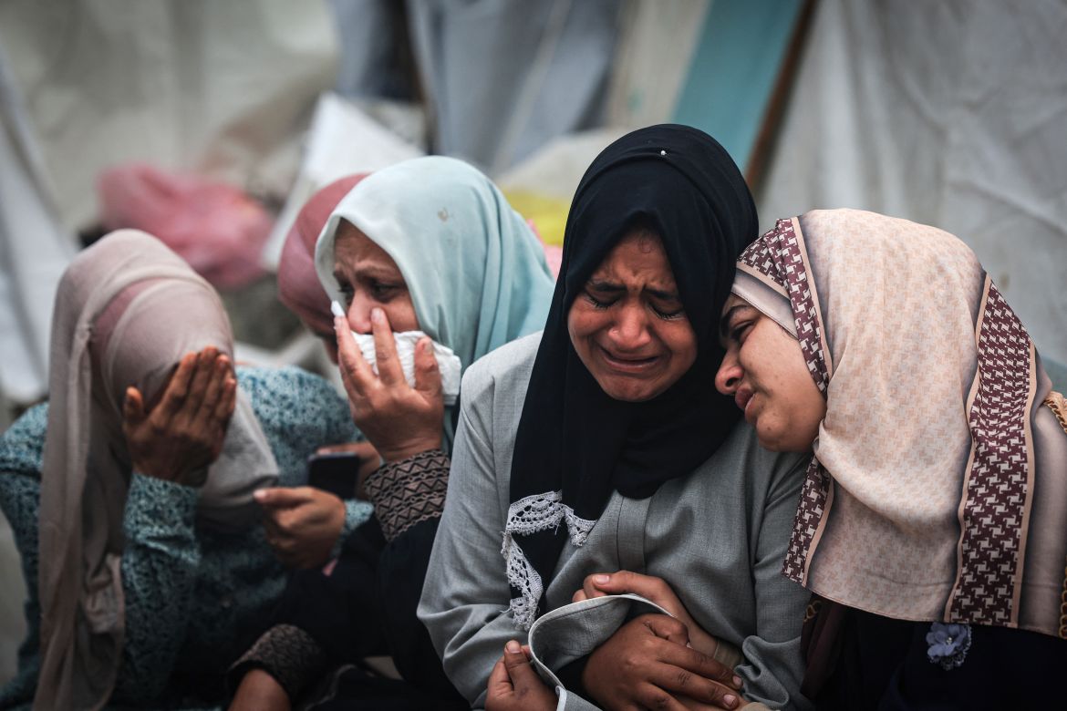 Palestinians mourn their relatives, killed in an overnight Israeli strike on the Al-Maghazi refugee camp, during a mass funeral at the Al-Aqsa hospital in Deir Al-Balah, in the southern Gaza Strip, on December 25
