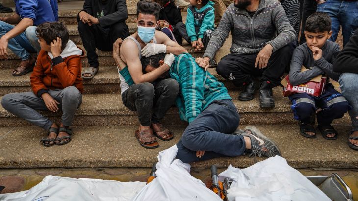 Palestinian mourn relatives killed in Israeli strike at the Nasser hospital in Khan Yunis