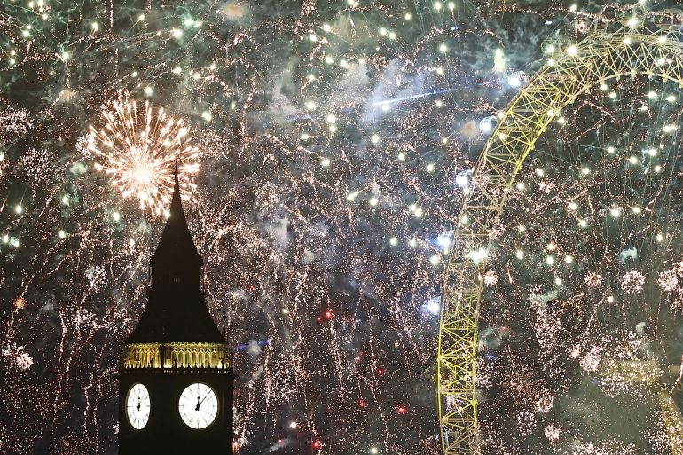 Fireworks exploding around Big Ben and the London Eye in London to mark the arrival of 2024