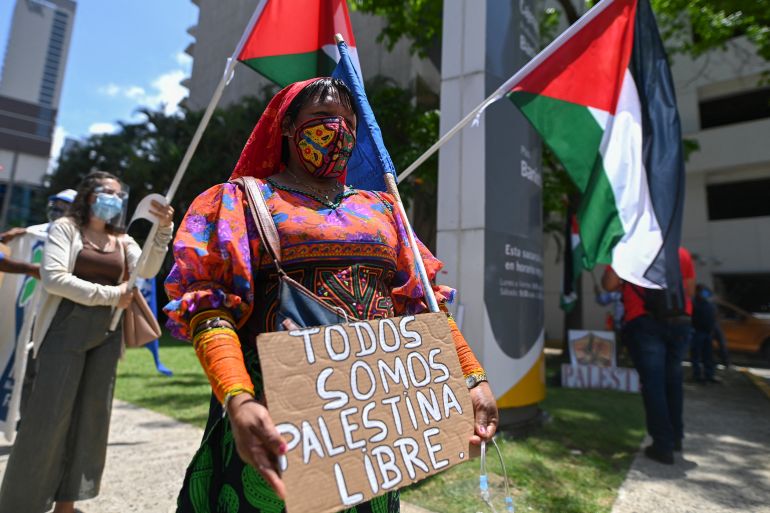 A Kuna indigenous woman joins members of the Palestinian community in Panama protesting outside the Israeli Embassy against Israel's military operations in Gaza and in support of the Palestinian people, in Panama City on May 20, 2021. (Photo by Luis Acosta / AFP)