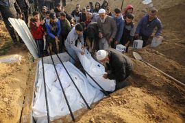 Palestinians killed in Israeli attacks are buried in mass graves in Deir al-Balah, Gaza on Saturday [Ashraf Amra/Anadolu Agency]