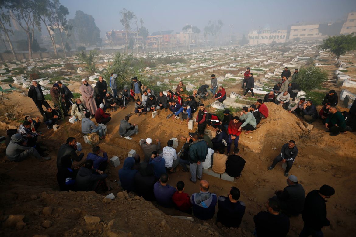 Palestinians who lost their lives in Israeli attacks are buried in mass graves as Israeli attacks continue in Deir al-Balah, Gaza on December 02