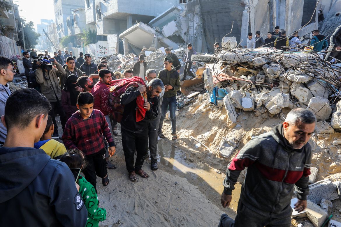 A lifeless body is pulled out among the rubble of the destroyed building after Israeli attacks hit the apartment belonging to the Azuum family in Rafah, Gaza on December 03, 2023. It is reported that, 12 civilians, including children and women