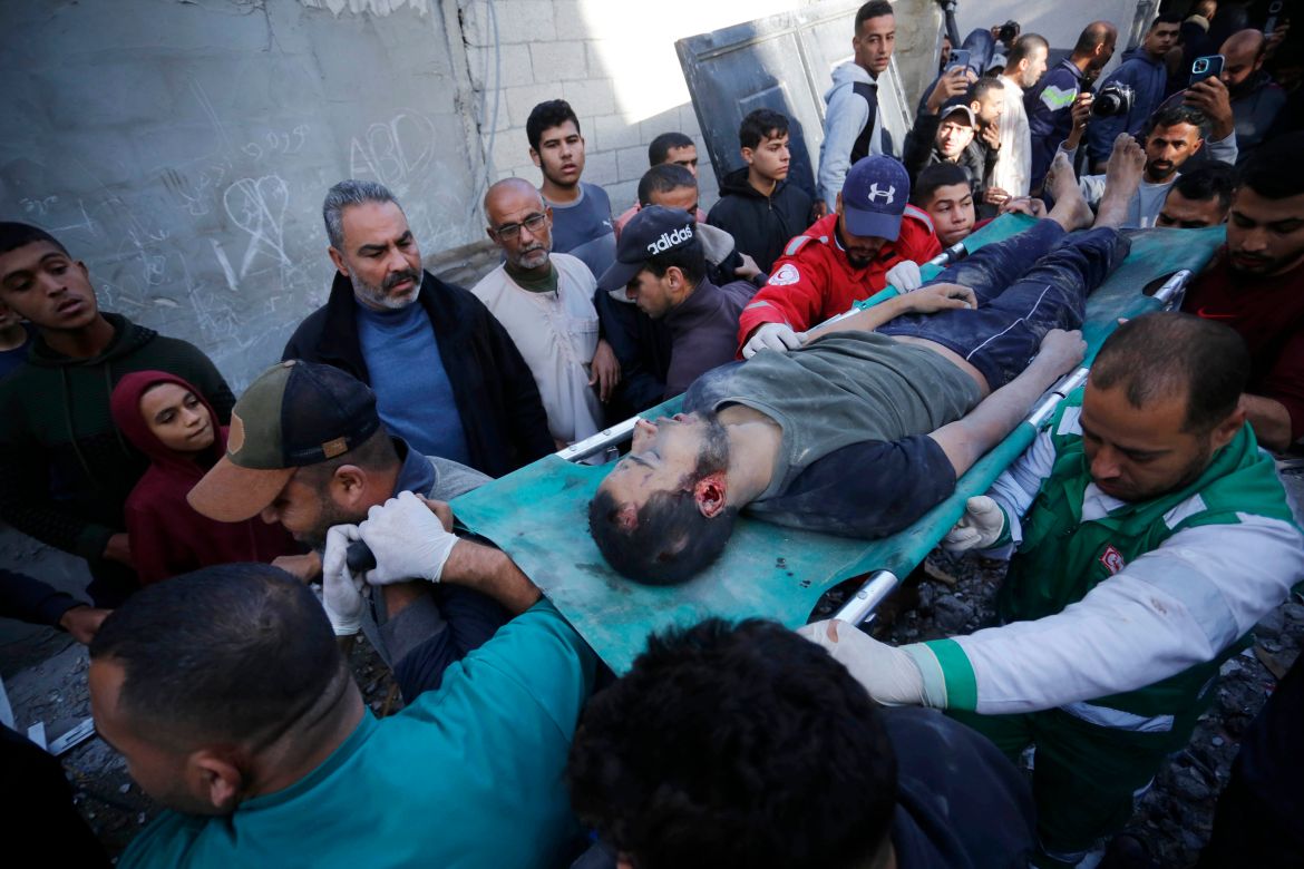A Palestinian is saved as the residents and civil defense teams conduct a search and rescue operation among demolished buildings after Israeli attacks in Deir Al-Balah, Gaza.
