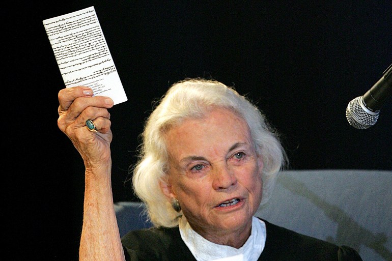 O'Connor holds up a copy of the US Constitution