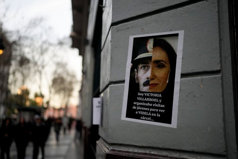 A poster on the side of a wall in Argentina shows a split image, half with the face of Victoria Villarruel and half with the face of dictator Jorge Rafael Videla