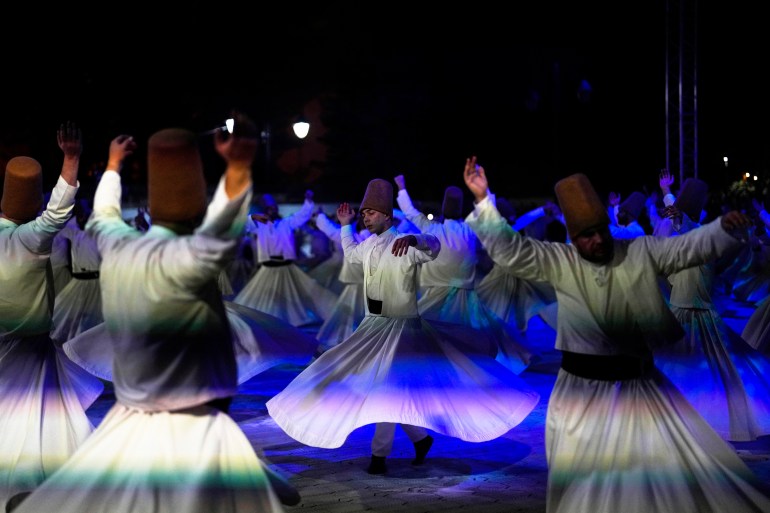 Whirling dervishes perform outside the Byzantine-era Hagia Sophia mosque in Istanbul, Turkey