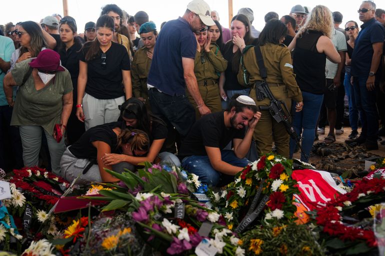 Mourners attend the funeral of the Kotz family in Gan Yavne, Israel, Tuesday, Oct. 17, 2023. The Israeli family of five was killed by Hamas militants on Oct. 7 at their house in Kibbutz Kfar Azza near the border with the Gaza Strip, More than 1,400 people were killed and some 200 captured in an unprecedented, multi-front attack by the militant group that rules Gaza. (AP Photo/Ohad Zwigenber)