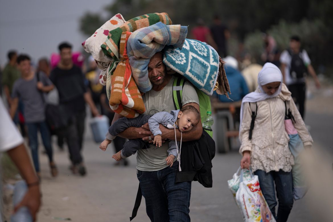 Palestinians flee to the southern Gaza Strip on Salah al-Din Street in Bureij, Gaza Strip