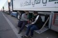 Humanitarian aid truck drivers drink tea as they wait to cross Rafah border crossing to Gaza Strip, Wednesday, Nov. 29, 2023. (AP Photo/Amr Nabil)