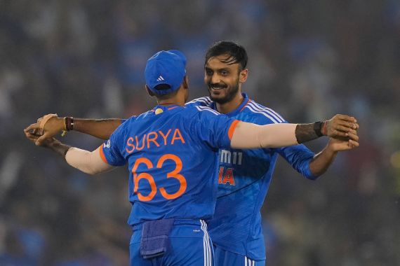 India's Axar Patel celebrates the dismissal of Australia's Ben McDermott with India's captain Suryakumar Yadav