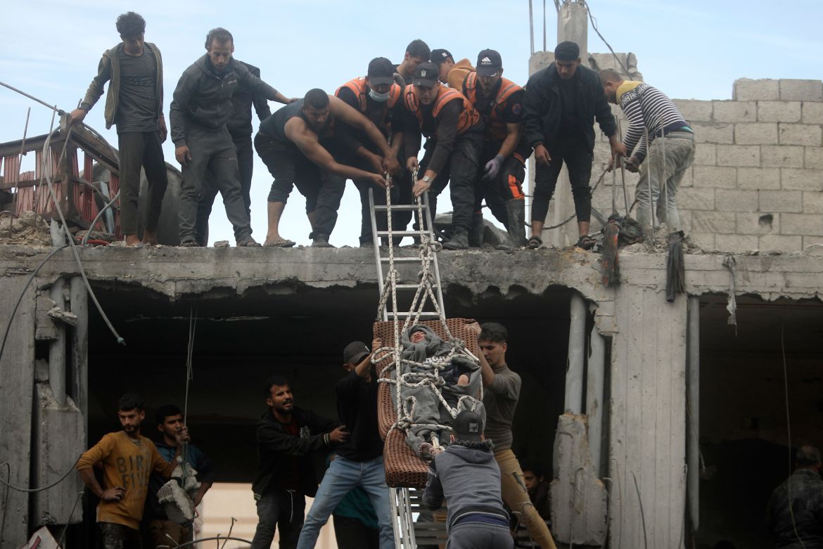 Palestinians rescue a man from a destroyed building following Israeli airstrikes in Khan Younis refugee camp, southern Gaza Strip.