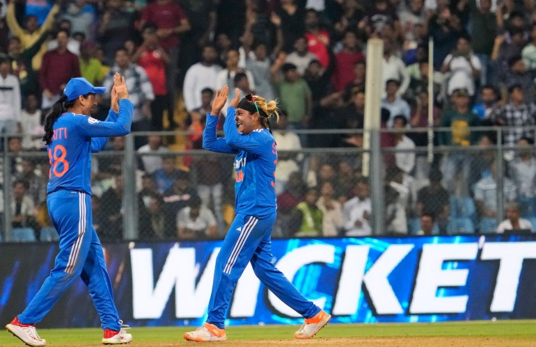 India's Saika Ishaque, right, celebrates the wicket of England's Amy Jones during the third and final T20 women's cricket match between England and India in Mumbai, India, Sunday, Dec. 10, 2023. (AP Photo /Rajanish Kakade)