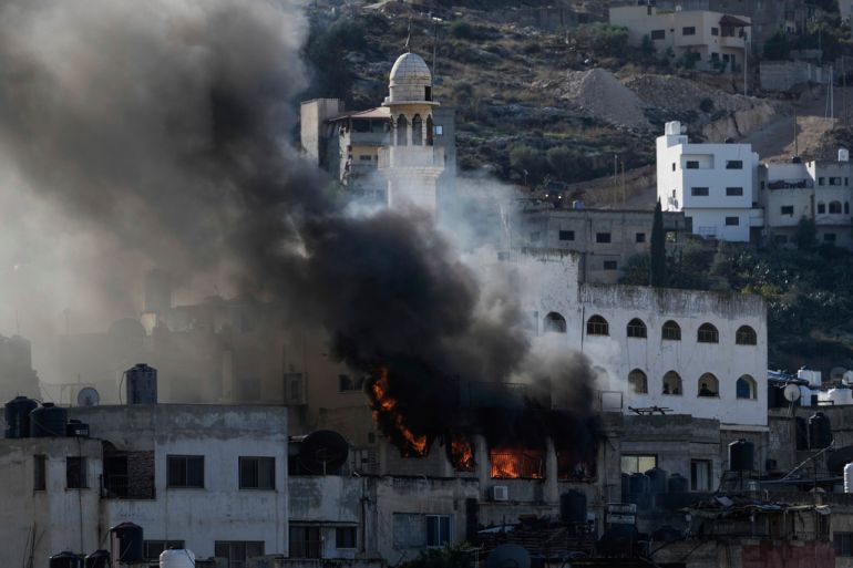 Fire and smoke rises during an Israeli army operation in Jenin, West Bank, Wednesday, Dec. 13, 2023. (AP Photo/Majdi Mohammed)