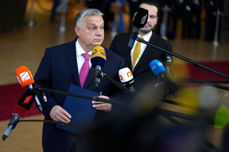 Hungarian Prime Minister Viktor Orban surrounded microphones