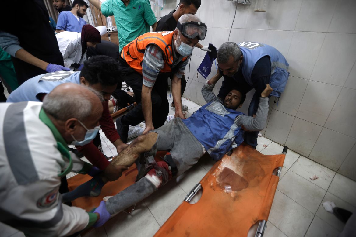 A United Nations worker wounded in Israeli airstrikes on a U.N.-run school arrives at the Nasser hospital in the town of Khan Younis, southern Gaza Strip.