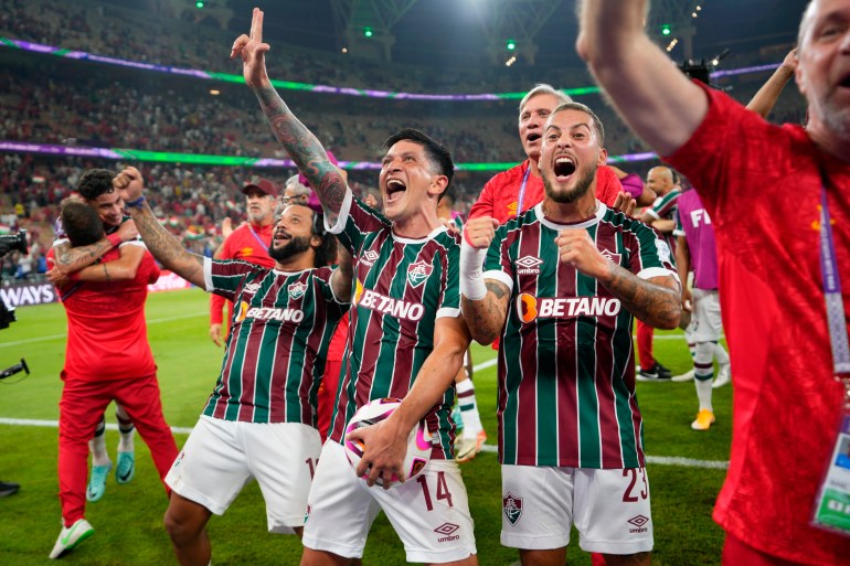 Fluminense's Marcelo, German Cano and Guga, from left, celebrate at the end of the Soccer Club World Cup semifinal soccer match between Fluminense FC and Al Ahly FC at King Abdullah Sports City Stadium in Jeddah, Saudi Arabia, Monday, Dec. 18, 2023. Fluminense won 2-0. (AP Photo/Manu Fernandez)