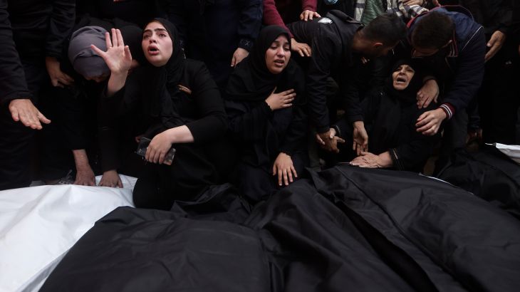 Palestinians mourn relatives killed in the Israeli bombardment of the Gaza Strip outside a morgue in Khan Younis