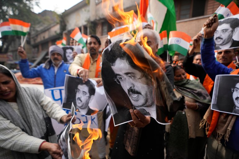 Activists of right-wing Hindu groups burn portraits of Pakistan's prime minster Anwaar-ul-Haq Kakar during a protest against the killings of Indian army soldiers, in Jammu, India, Friday, Dec. 22, 2023. Four Indian soldiers were killed and three others were wounded in an ambush by militants fighting against New Delhi’s rule in disputed Kashmir, officials said on Thursday. The Indian military said militants fired at two army vehicles in southern Poonch district late afternoon on Thursday. The area is close to the highly militarized line of control that divides Kashmir between India and Pakistan. (AP Photo/Channi Anand)