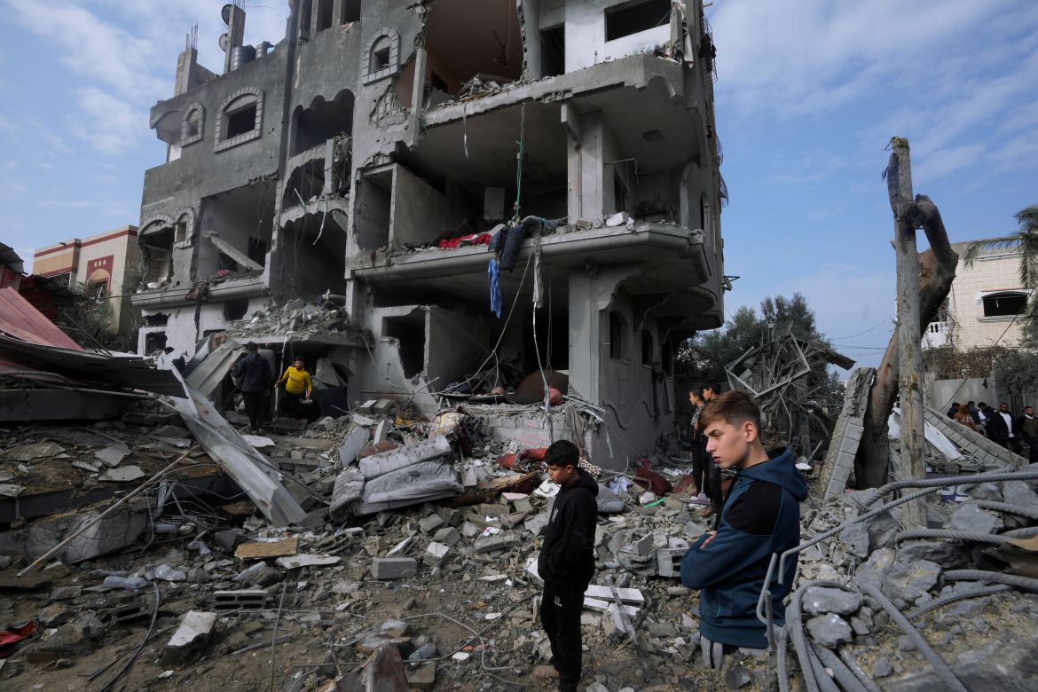 Palestinians inspect the rubble of a building of the Al Nawasrah family destroyed in an Israeli strike in Maghazi refugee camp, central Gaza Strip, Monday, Dec. 25