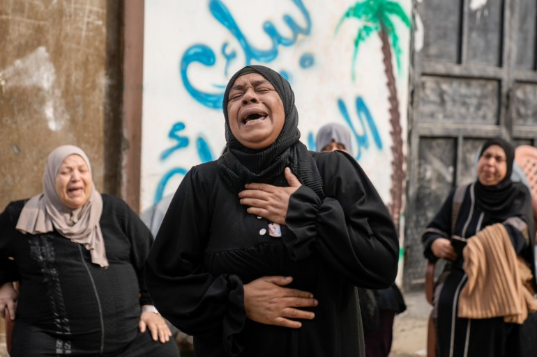 Palestinian women mourn after an Israeli military raid on Nur Shams refugee camp in the West Bank