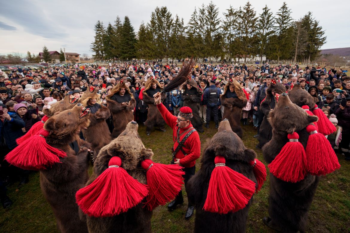 Members of the Sipoteni bear pack perform a ritual dance in Racova, northern Romania, Tuesday, Dec. 26