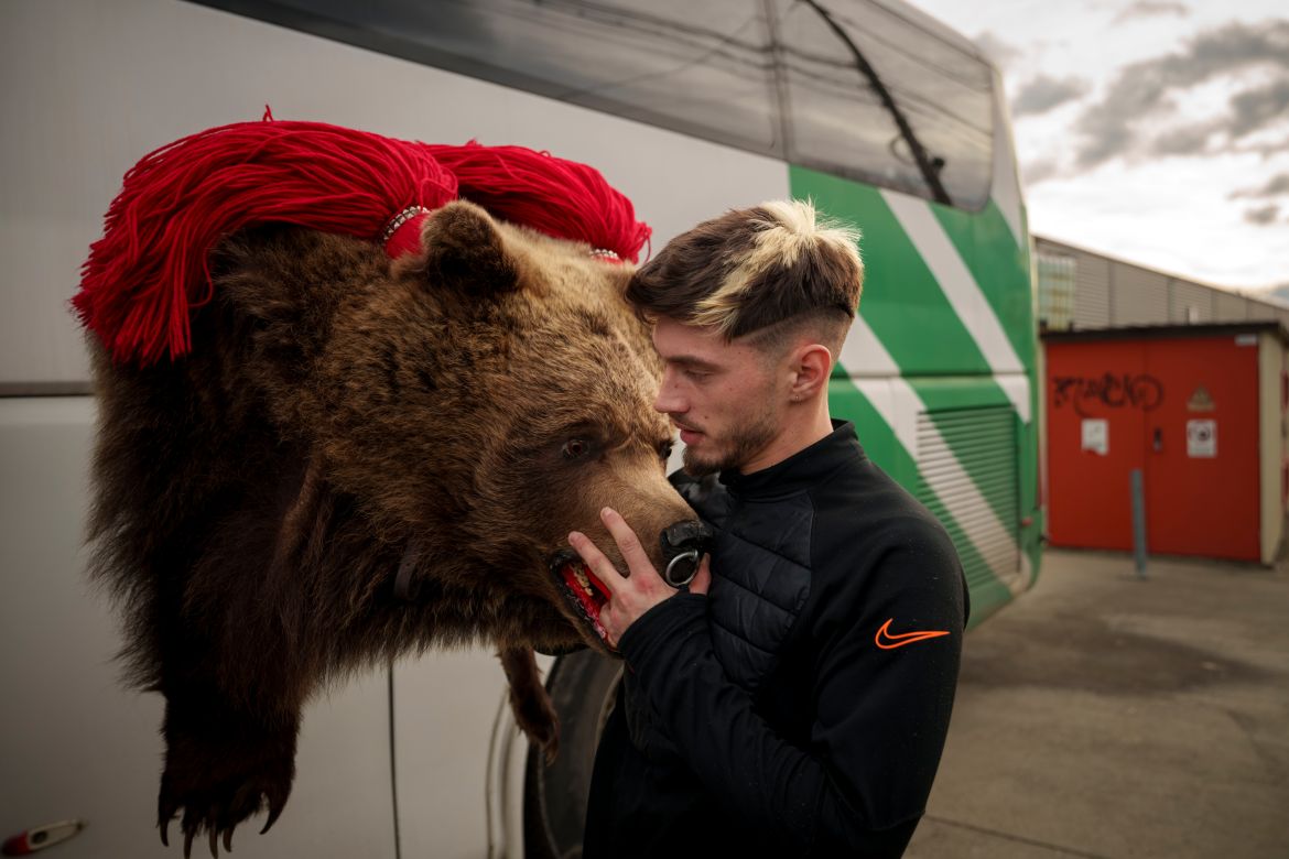 A member of the Sipoteni bear pack loads his costume on a bus, in Comanesti, northern Romania, Tuesday, Dec. 26