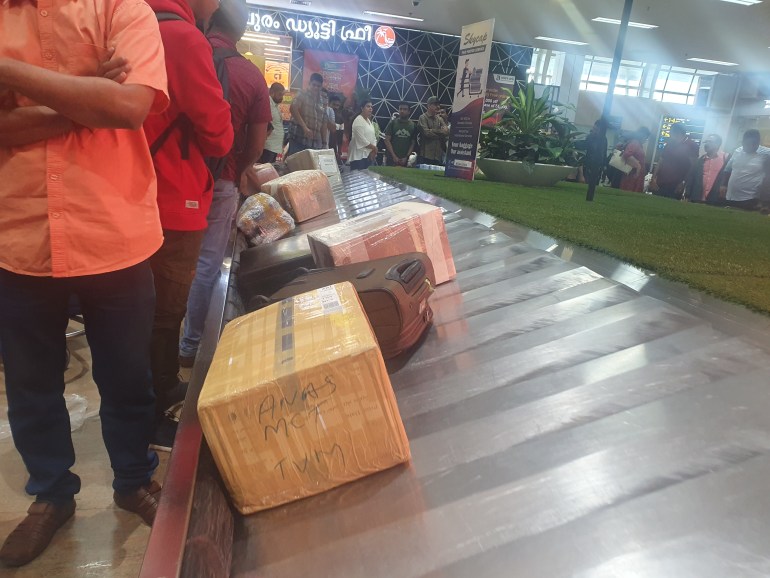 Brown cartons moving along with other suitcases from Bahrain on the conveyor belt at Thiruvananthapuram International Airport on October 31 [Rejimon Kuttappan/Al Jazeera]