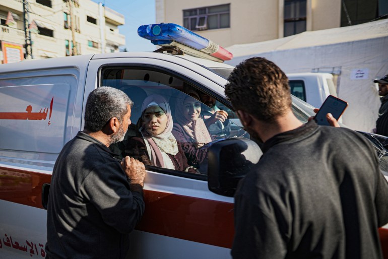 Sawsan Abu Odeh and Noor Reyhan bid farewell to Swan's father Khaled and Noor's husband Huthaifa from inside the ambulance that will take them to the Rafah border crossing 