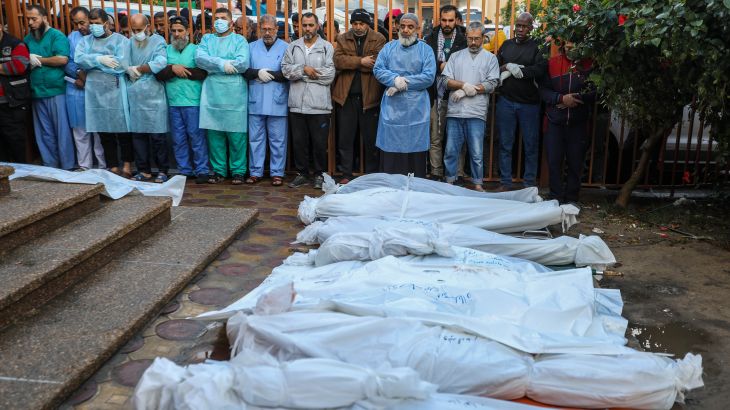 People mourn as they collect the bodies of Palestinians killed in an Israeli airstrike