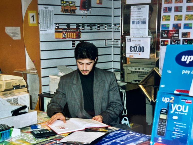 Waheed working as a shopkeeper in his early days in London -- this was one of the three jobs that he took on to support himself and save up for college and university-1702407711