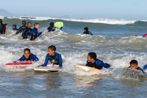 Kids ride waves on bodyboards
