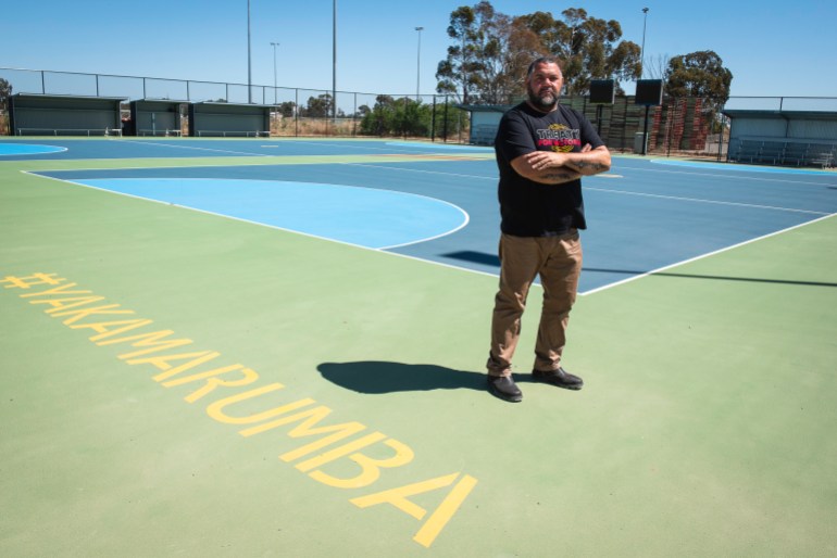Brad Boon. He's standing on the new netball court that the community got built