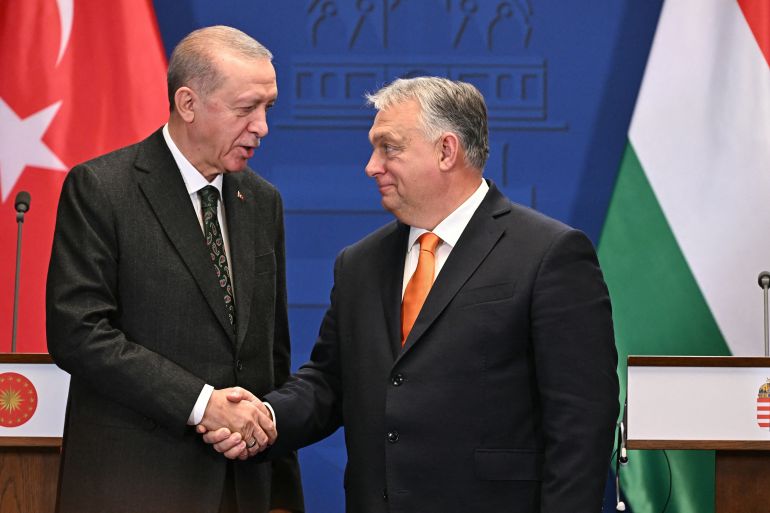 Hungarian Prime Minister Viktor Orban (R) and Turkish President Recep Tayyip Erdogan shake hands at a joint press conference after talks at the prime minister's office at the Carmelite Monastery in Budapest, Hungary, on December 18, 2023. [ATTILA KISBENEDEK / AFP]