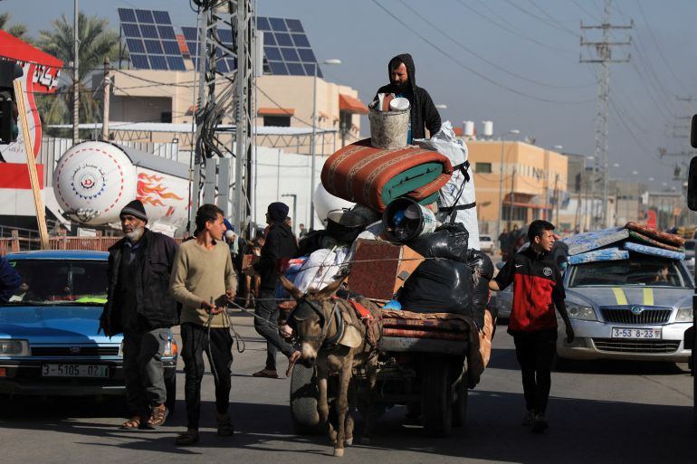 Palestinians transport belongings on an animal-drawn cart, as they flee their houses after they were ordered by the Israeli army to evacuate the area, in Bureij in the central Gaza Strip December 26, 2023. [REUTERS/Mohammed Al-Masri]