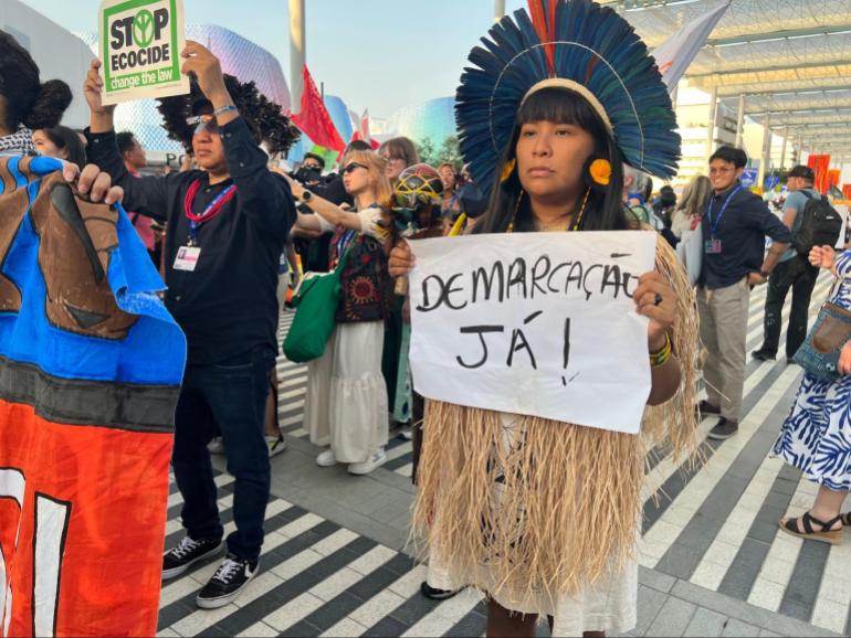 Raquel Tupinamba, Indigenous leader from the Tupinamba community in Pará, Brazil marching in at a climate protest, demanding land rights, at the COP28 in Dubai