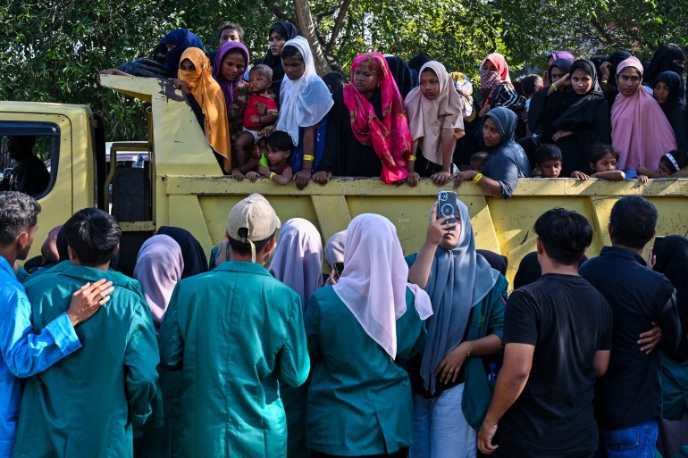 Rohingya refugees crowd into a vehicle for relocation to a nearby government building after demonstrating university students forced them out of the current government facility, in Banda Aceh on December 27, 2023. [CHAIDEER MAHYUDDIN / AFP]