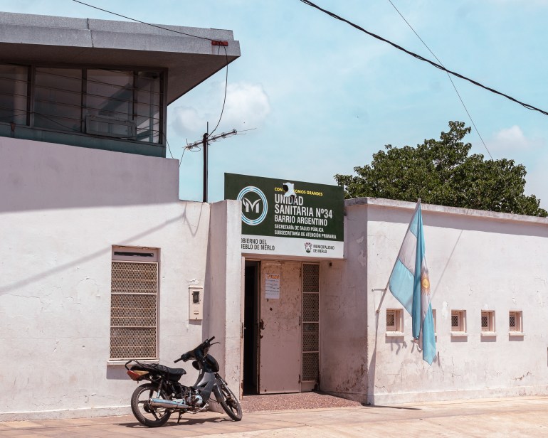 A primary healthcare centre that offers psychological services in Moreno, a marginalised area in the outskirts of Buenos Aires. A motorbike is parked outside the white stucco walls of the centre.