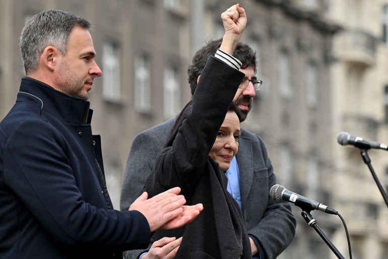 Serbian opposition leader Marinika Tepic (C), who was on hunger strike for 13 days appears on the stage, flanked by her opposition colleagues Miroslav Aleksic (L) and Radomir Lazovic (R), as several thousands of people attend an opposition rally [Andrej ISAKOVIC / AFP]