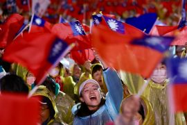 Supporters of Taiwan's KMT waving the national flag at a rally