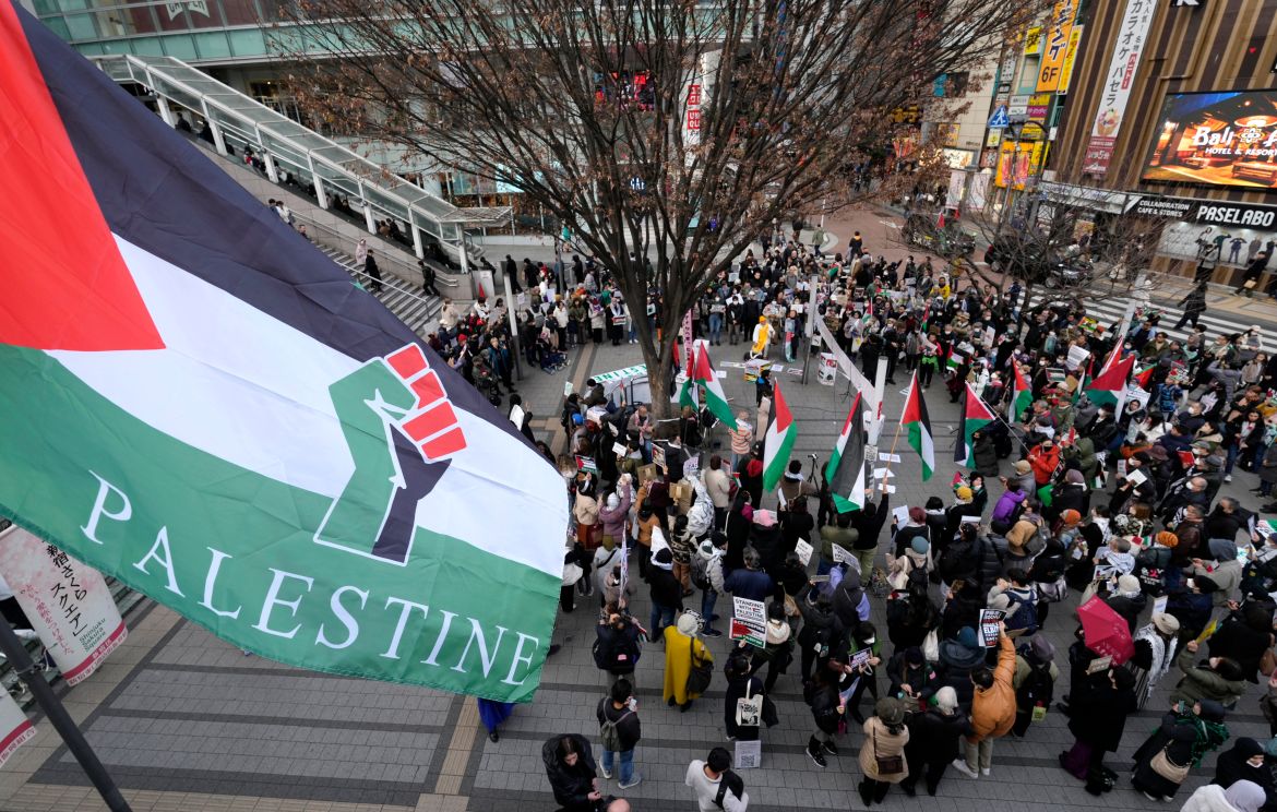 Demonstrators hold banners and wave Palestinians flags during a rally in solidarity with the Palestinian people amid the ongoing conflict between Israel and Hamas in Tokyo, Japan