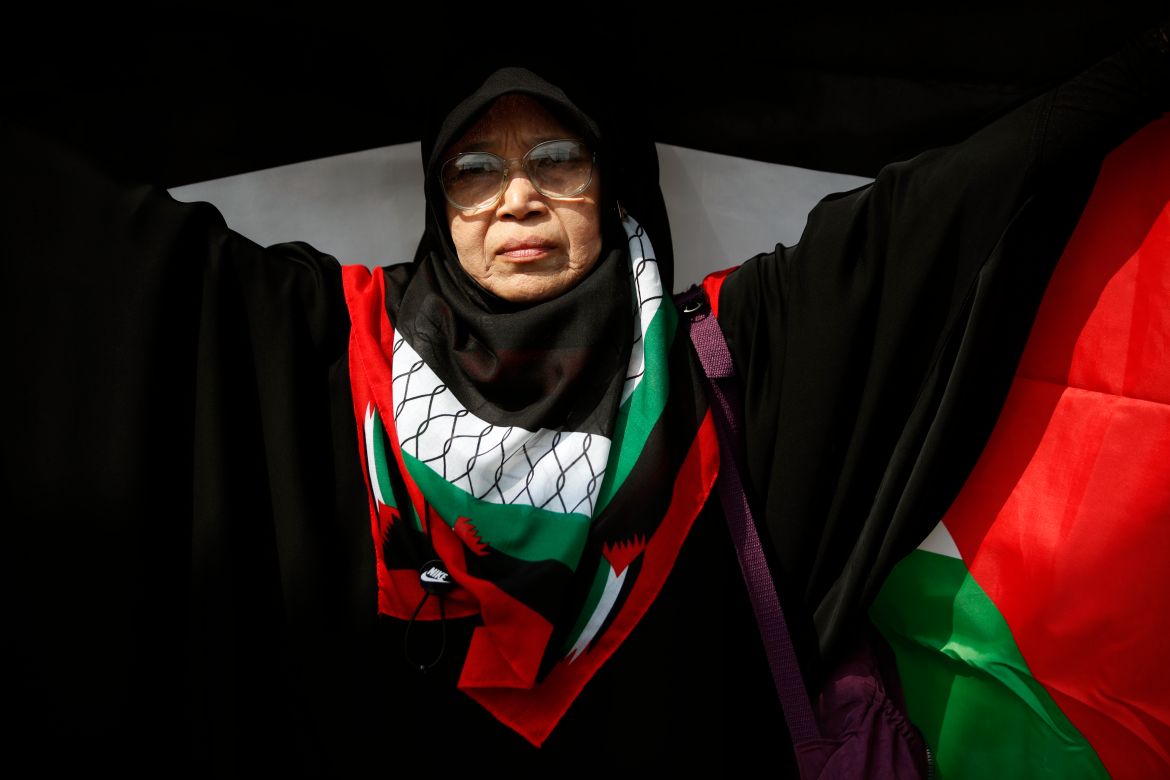 A Thai-Muslim demonstrator holds a large Palestinian flag during a protest calling for a permanent ceasefire in the Gaza Strip to mark the Global Day of Action for Gaza at the US embassy in Bangkok