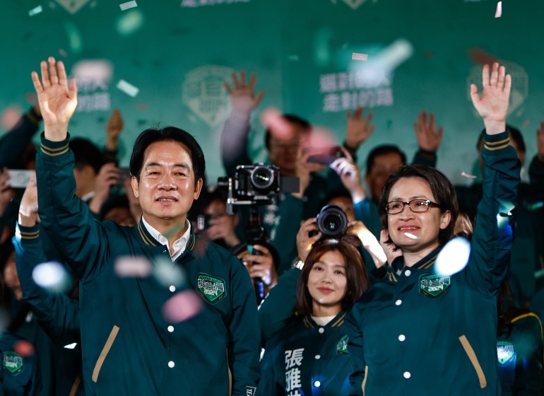 Lai Ching-te and Hsiao Bi-khim wave and smile after their election victory. Colourful ticker-tape is falling around them