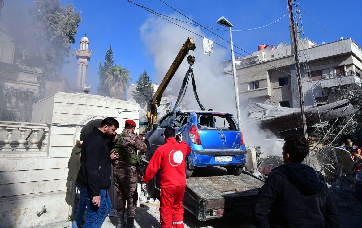 Rescuers work at the site of residential building after an alleged Israeli strike in Mezzah neighborhood, Damascus, Syria, 20