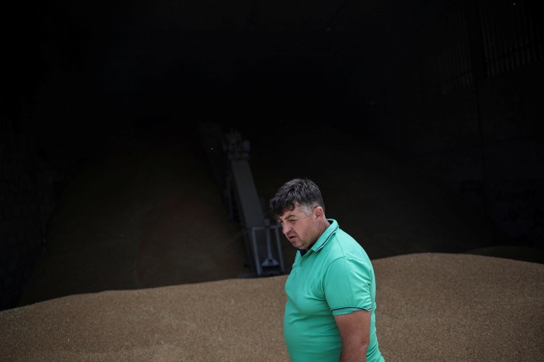 Farmer Vitalii Kistrytsya, 45, walks next to grain at his grain storage facility, as Russia's attack on Ukraine continues, in Dnipropetrovsk region, Ukraine, July 30, 2022. REUTERS/Alkis Konstantinidis