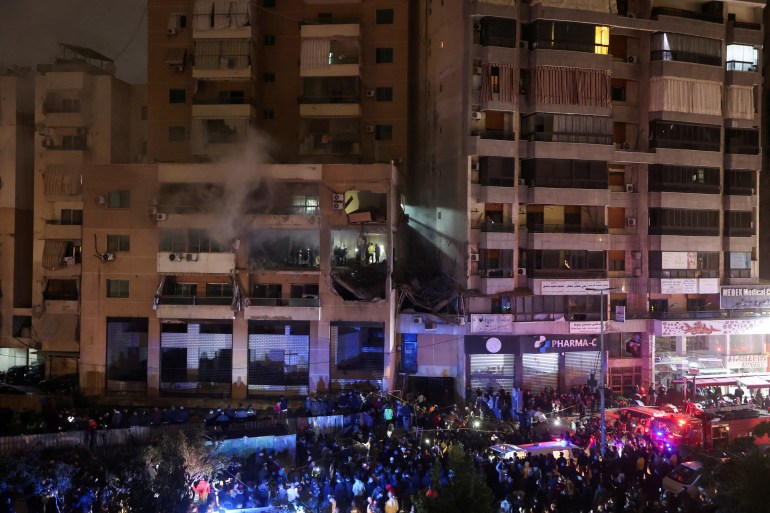 People gather near a damaged site following an explosion
