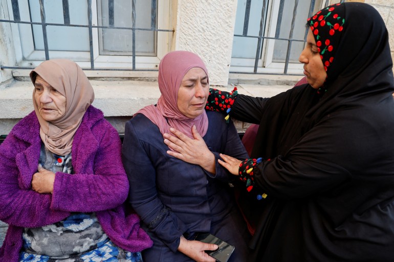 A woman wearing the pink hijab mourns, after four children of hers were killed in what Palestinian authorities said was an Israeli air strike, at a morgue in Jenin