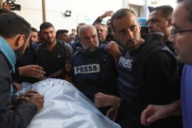 Al Jazeera journalist Wael Dahdouh, centre, attends the funeral of his son and fellow journalist Hamza Dahdouh after Hamza was killed in an Israeli air strike in the southern Gaza Strip on January 7, 2024 [Ibraheem Abu Mustafa/Reuters]